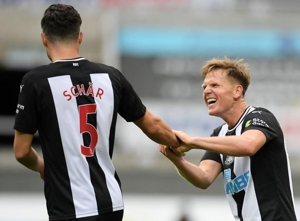 Matt Ritchie celebrates with Fabian Schar.