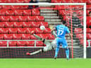 Gareth Evans scores the winning penalty for Bradford City