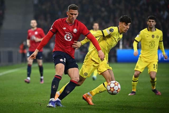 Lille's Dutch defender Sven Botman (L) fights for the ball with Chelsea's German midfielder Kai Havertz  during the UEFA Champions League round of 16 second leg football match between Lille (LOSC) and Chelsea FC at the Pierre Mauroy Stadium in Villeneuve-d'Ascq, northern France, on March 16, 2022. (Photo by FRANCK FIFE/AFP via Getty Images)