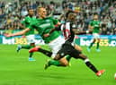 NEWCASTLE UPON TYNE, ENGLAND - SEPTEMBER 21: Christian Atsu of Newcastle is tackled by Dan Burn of Brighton during the Premier League match between Newcastle United and Brighton & Hove Albion at St. James Park on September 21, 2019 in Newcastle upon Tyne, United Kingdom. (Photo by Mark Runnacles/Getty Images)