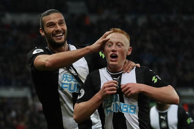 Matty Longstaff celebrates with team-mate Andy Carroll after scoring on his Premier League debut.