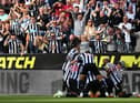 NEWCASTLE UPON TYNE, ENGLAND - AUGUST 21: Fans of Newcastle United celebrate as Kieran Trippier of Newcastle United celebrates with teammates after scoring their side's third goal from a free kick during the Premier League match between Newcastle United and Manchester City at St. James Park on August 21, 2022 in Newcastle upon Tyne, England. (Photo by Stu Forster/Getty Images)