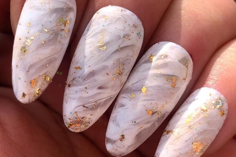 SparkleWithCm sells Custom made press on nails. These have a marble effect with gold flakes.