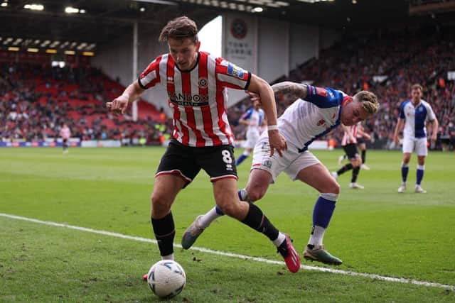 Sander Berge of Sheffield United battles for possession with Sammie Szmodics of Blackburn Rovers during the Emirates FA Cup Quarter Final match between Sheffield United and Blackburn Rovers at Bramall Lane on March 19, 2023 in Sheffield, England. (Photo by Naomi Baker/Getty Images)