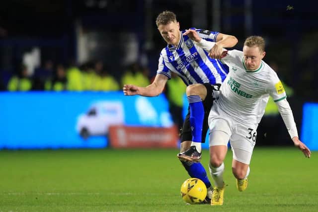 Sheffield Wednesday's English striker Michael Smith (L) vies with Newcastle United's English midfielder Sean Longstaff (R) during the English FA Cup third round football match between Sheffield Wednesday and Newcastle United at Hillsborough Stadium in Sheffield, northern England on January 7, 2023. (Photo by LINDSEY PARNABY/AFP via Getty Images)