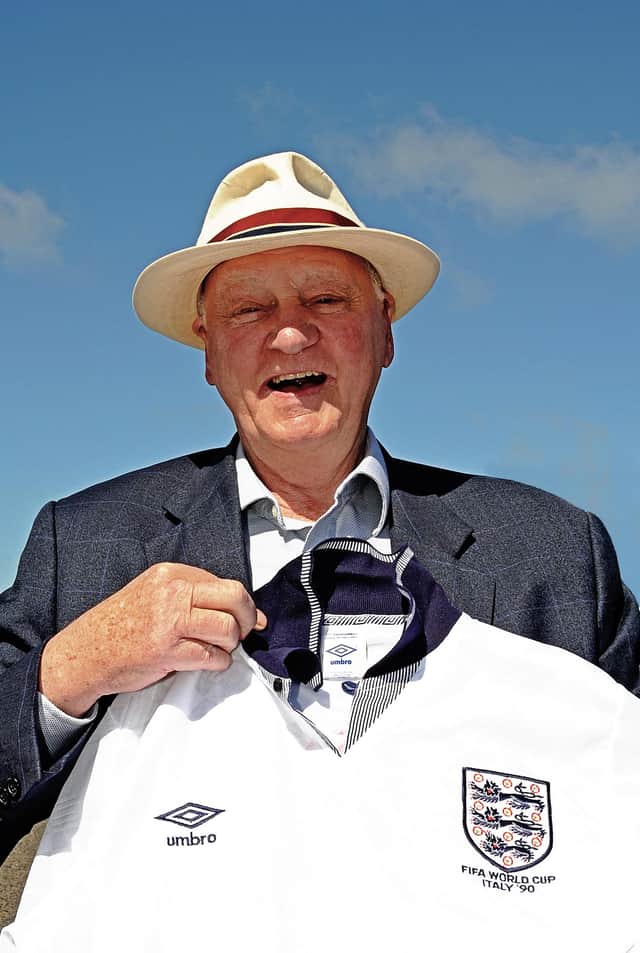Sir Bobby pictured in 2009 with an England Italia 90 shirt.