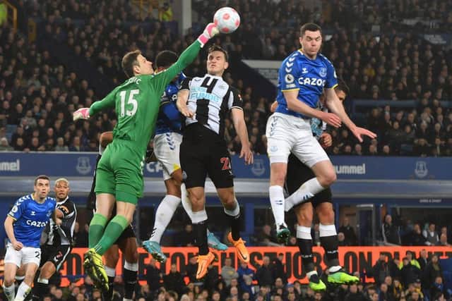 Everton's Bosnian goalkeeper Asmir Begovic punches the ball clear during the English Premier League football match between Everton and Newcastle United at Goodison Park in Liverpool, north west England on March 17, 2022. (Photo by ANTHONY DEVLIN/AFP via Getty Images)