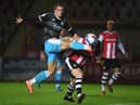 Max Watters of Crawley Town looks to break past Pierce Sweeney of Exeter City during the Sky Bet League Two match between Exeter City and Crawley Town at St James Park.