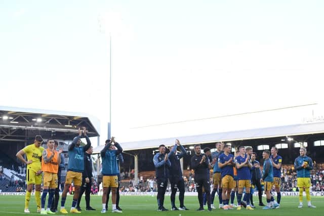 Newcastle United players and staff applaud fans at the final whistle.