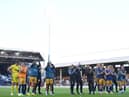 Newcastle United players and staff applaud fans at the final whistle.