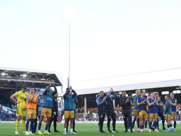 Newcastle United players and staff applaud fans at the final whistle.
