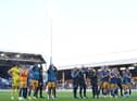 Newcastle United players and staff applaud fans at the final whistle.