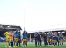 Newcastle United players and staff applaud fans at the final whistle.
