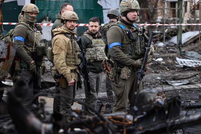 President Volodymyr Zelensky walks in the town of Bucha, just northwest of the Ukrainian capital Kyiv on April 4, 2022. President Zelensky has said  the Russian leadership was responsible for civilian killings in Bucha, outside Kyiv, where bodies were found lying in the street after the town was retaken by the Ukrainian army. (Photo by RONALDO SCHEMIDT / AFP) (Photo by RONALDO SCHEMIDT/AFP via Getty Images)