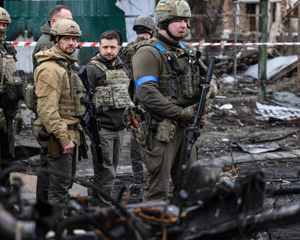 President Volodymyr Zelensky walks in the town of Bucha, just northwest of the Ukrainian capital Kyiv on April 4, 2022. President Zelensky has said  the Russian leadership was responsible for civilian killings in Bucha, outside Kyiv, where bodies were found lying in the street after the town was retaken by the Ukrainian army. (Photo by RONALDO SCHEMIDT / AFP) (Photo by RONALDO SCHEMIDT/AFP via Getty Images)