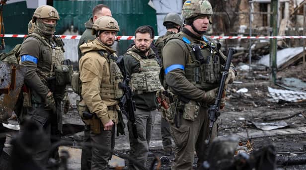President Volodymyr Zelensky walks in the town of Bucha, just northwest of the Ukrainian capital Kyiv on April 4, 2022. President Zelensky has said  the Russian leadership was responsible for civilian killings in Bucha, outside Kyiv, where bodies were found lying in the street after the town was retaken by the Ukrainian army. (Photo by RONALDO SCHEMIDT / AFP) (Photo by RONALDO SCHEMIDT/AFP via Getty Images)