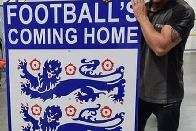 Ben Fada with the England badge that he attempted to put on the Angel of the North.