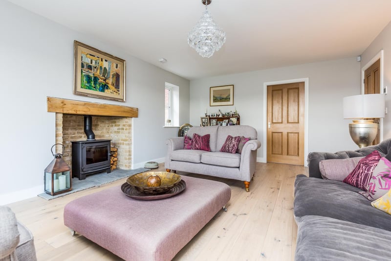 Relax in this attractive living room with feature fireplace with log burner