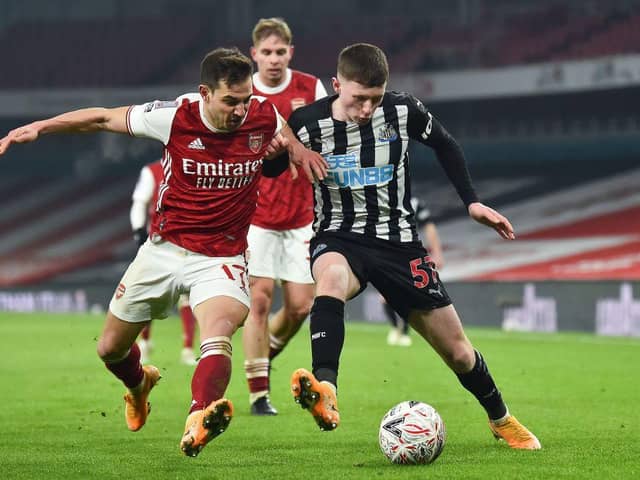 Cedric Soares (L) with Newcastle United's English midfielder Elliot Anderson (R) during the English FA Cup third round football match between Arsenal and Newcastle United at the Emirates Stadium in London on January 9, 2021(Photo by GLYN KIRK/AFP via Getty Images)