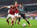Cedric Soares (L) with Newcastle United's English midfielder Elliot Anderson (R) during the English FA Cup third round football match between Arsenal and Newcastle United at the Emirates Stadium in London on January 9, 2021(Photo by GLYN KIRK/AFP via Getty Images)