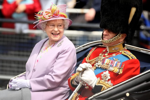 Queen Elizabeth II and the Duke of Edinburgh return to Buckingham Palace by carriage following the Trooping the Colour ceremony at Horse Guards Parade. 12/06/10