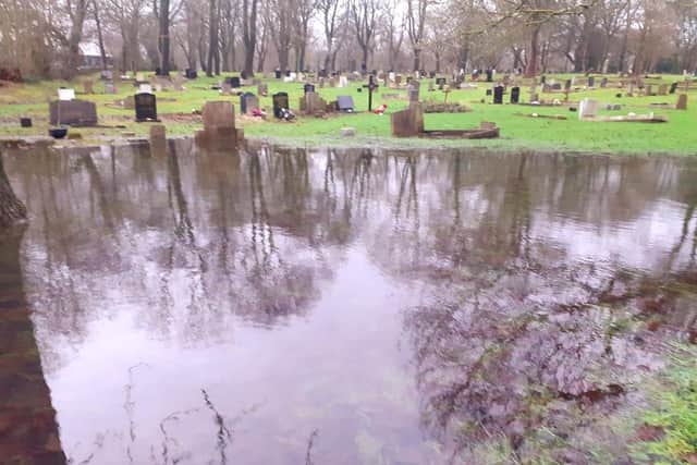 Distressing sight. A number of graves were left under water.