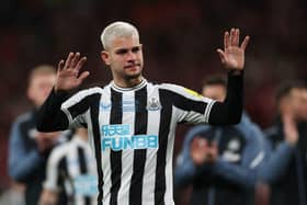 Newcastle United midfielder Bruno Guimaraes gestures to fans at Wembley.