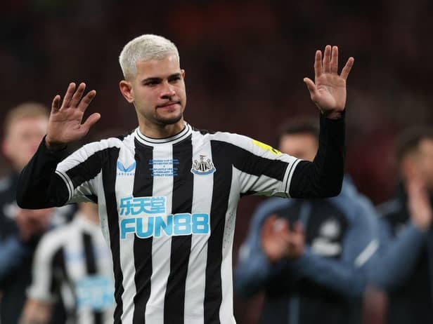 Newcastle United midfielder Bruno Guimaraes gestures to fans at Wembley.
