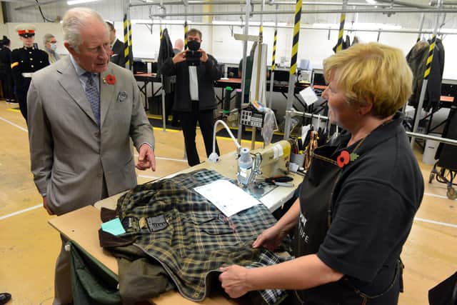 King Charles III, then the Prince of Wales, chats with Barbour machinist Julie-Anne Sheville.
