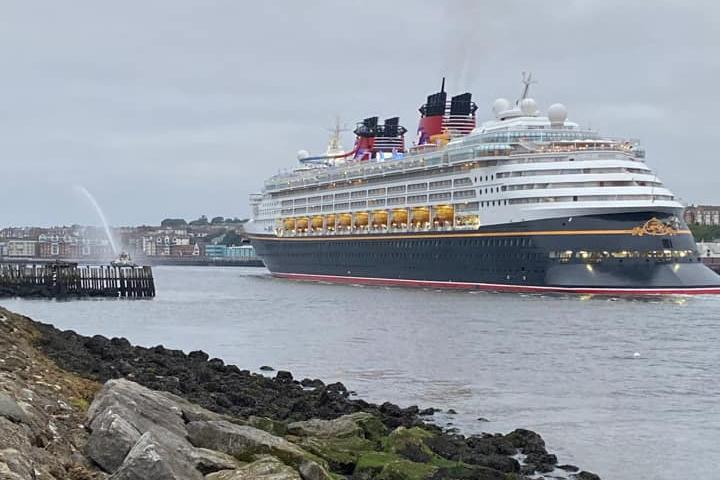 Can you spot the liner's water-spraying tug in the background? It's quite the display!