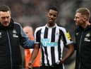 Newcastle United striker Alexander Isak leaves the pitch after being struck on the head with a ball.`