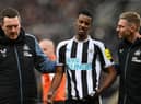 Newcastle United striker Alexander Isak leaves the pitch after being struck on the head with a ball.`