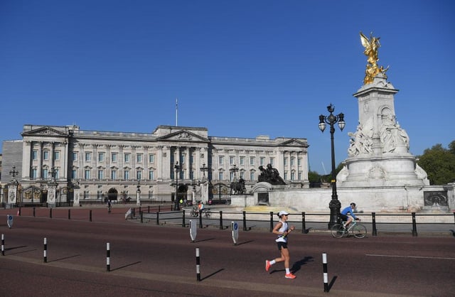 A jogger passes Buckingham Palace; the 40th London Marathon was due to take place this weekend, but has been postponed until October due to coronavirus (Photo: Alex Davidson/Getty Images)
