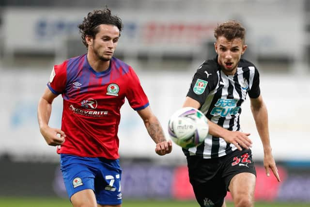 Dan Barlaser challenges Blackburn Rovers' Lewis Travis.