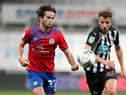 Dan Barlaser challenges Blackburn Rovers' Lewis Travis.