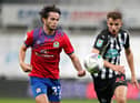 Dan Barlaser challenges Blackburn Rovers' Lewis Travis.
