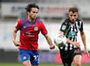 Dan Barlaser challenges Blackburn Rovers' Lewis Travis.