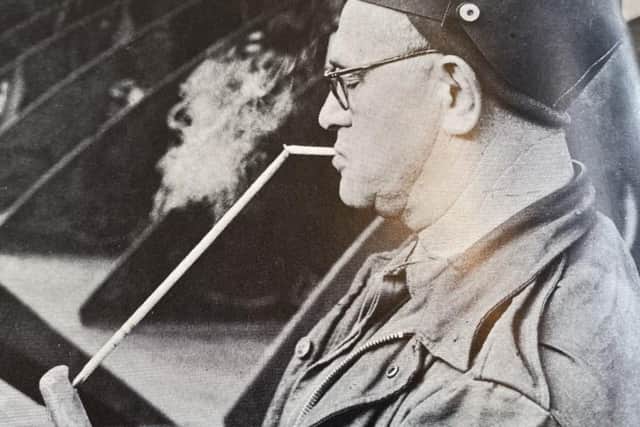 John Short lighting a cigarette with welding torch.