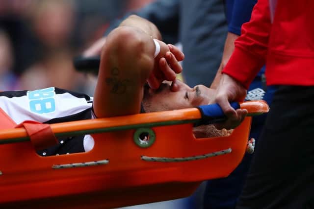 Joelinton of Newcastle United is stretchered off after suffering an injury during the Premier League match between Burnley and Newcastle United at Turf Moor on May 22, 2022 in Burnley, England. (Photo by Jan Kruger/Getty Images)
