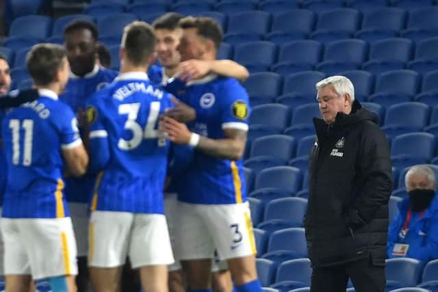 Newcastle United's English head coach Steve Bruce (R) reacts as Brighton's English striker Danny Welbeck celebrates scoring his team's second goal with his teammates during the English Premier League football match between Brighton and Hove Albion and Newcastle United at the American Express Community Stadium in Brighton, southern England on March 20, 2021.