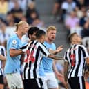 NEWCASTLE UPON TYNE, ENGLAND - AUGUST 21: Kieran Trippier of Newcastle United is shown a red card by referee Jarred Gillett which is later overturned to a yellow card  during the Premier League match between Newcastle United and Manchester City at St. James Park on August 21, 2022 in Newcastle upon Tyne, England. (Photo by Stu Forster/Getty Images)