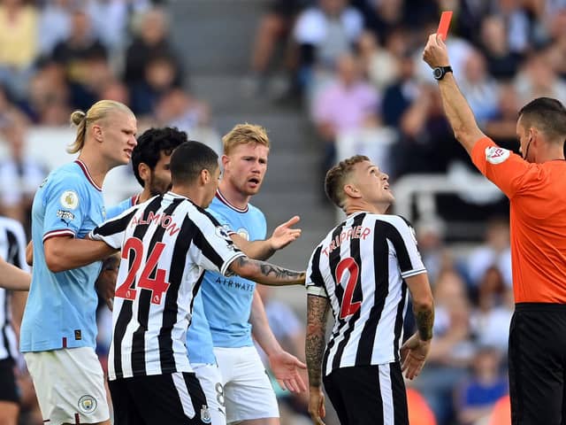 Kieran Trippier of Newcastle United is shown a red card by referee Jarred Gillett which is later overturned to a yellow card  during the Premier League match between Newcastle United and Manchester City at St. James Park on August 21, 2022 in Newcastle upon Tyne, England. (Photo by Stu Forster/Getty Images)