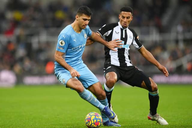 Rodrigo of Manchester City holds off Isaac Hayden of Newcastle United during the Premier League match between Newcastle United and Manchester City at St. James Park on December 19, 2021 in Newcastle upon Tyne, England. (Photo by Stu Forster/Getty Images)