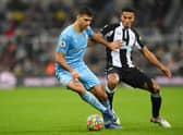 Rodrigo of Manchester City holds off Isaac Hayden of Newcastle United during the Premier League match between Newcastle United and Manchester City at St. James Park on December 19, 2021 in Newcastle upon Tyne, England. (Photo by Stu Forster/Getty Images)