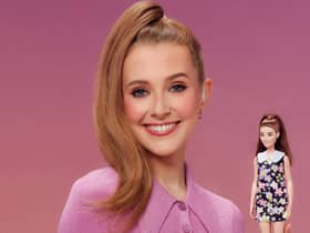 Rose Ayling-Ellis poses with the first ever Barbie doll with a behind-the-ear hearing aid