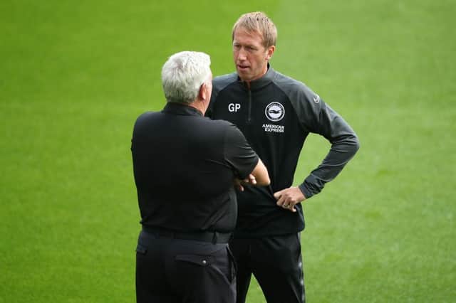 Newcastle United's English head coach Steve Bruce (L) chats with Brighton's English manager Graham Potter (R) on the pitch ahead of the English Premier League football match between Newcastle United and Brighton and Hove Albion at St James' Park in Newcastle upon Tyne, north-east England on September 20, 2020.