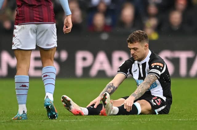 Newcastle full back Kieran Trippier sits down on the turf before leaving the field. (Photo by Stu Forster/Getty Images)