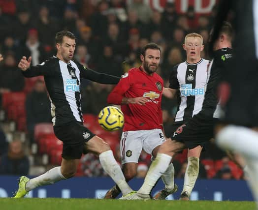 MANCHESTER, ENGLAND - DECEMBER 26: Juan Mata of Manchester United in action with Matty Longstaff of Newcastle United during the Premier League match between Manchester United and Newcastle United at Old Trafford on December 26, 2019 in Manchester, United Kingdom. (Photo by Matthew Peters/Manchester United via Getty Images)