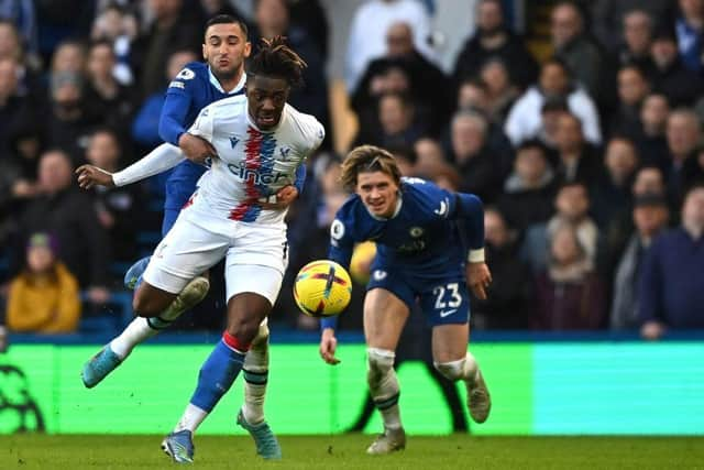 Crystal Palace's English midfielder Eberechi Eze (C) is held back by Chelsea's Moroccan midfielder Hakim Ziyech (L) as Conor Gallagher watches on during the English Premier League football match between Chelsea and Crystal Palace at Stamford Bridge in London on January 15, 2023.  (Photo by BEN STANSALL/AFP via Getty Images)