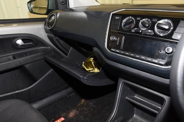 Police found the handgun hidden inside of a stolen car's glove box.